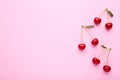 Cherry pattern. Flat lay of cherries on a pink background.Top view