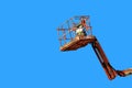 Cherry picker on blue Royalty Free Stock Photo