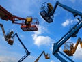 A group of cherry pickers, aerial work platforms, seen from below