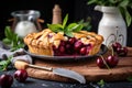 cherry pie being served on a platter, with sprig of fresh herbs and a wedge of lemon