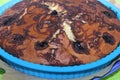 Cherry pie with brown crust in blue silicone form