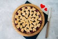 Cherry pie with heart shape decorations from flaky dough on a white backdrop Royalty Free Stock Photo