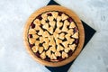 Cherry pie with heart shape decorations from flaky dough on a white backdrop Royalty Free Stock Photo