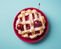 a cherry pie with a lattice on a blue background