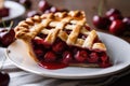 cherry pie, with a lattice crust, on white plate