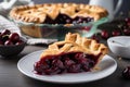 cherry pie on a white plate with slice cut out for serving