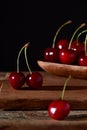 Cherry in a plate on a wooden background Royalty Free Stock Photo