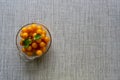 Cherry plum in the glass bowl on the table. Copy space. Above view