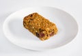 Cherry and raisin flapjack on a white plate