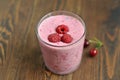 Cherry and Raspberry Smoothies in a Glass Cup. Fresh raspberries in it. Dark wooden table. Royalty Free Stock Photo