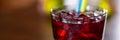 Cherry red alkohol drink on wooden table closeup