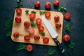 Cherry red tomatoes slices with knife on chopping board for making ketchup. Organic vegetables for making tasty full of vitamins