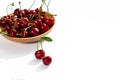 Ripe red cherry with green leaves lies on a white background Royalty Free Stock Photo