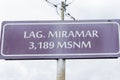 Cherry sign where it says Lagoon Miramar 3,189 masl located on a pole in the morning