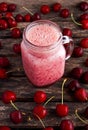 Cherry smoothie in jar glass on wooden table. healthy food concept for breakfast or snack. Royalty Free Stock Photo