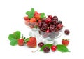 Cherry and strawberry in glass bowls on white background Royalty Free Stock Photo