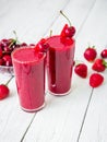 Cherry and strawberry smoothie and tasty berries on white rustic table. Fresh natural milkshake Royalty Free Stock Photo