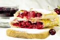 Cherry strudel with white dishes close up Royalty Free Stock Photo