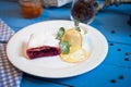 Cherry strudel on a white plate with lemon on