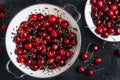 Cherry. Sweet Cherries in white colander on dark stone concrete background. Ripe Sweet Red Cherries Royalty Free Stock Photo