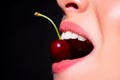 Cherry in teeth, macro, close up. Cherry in woman mouth. Cherries on woman lips. Girl biting cherry. Beautiful girl