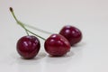 Cherry. Three berries isolated on white. Three red cherries on white background. Three red cherries on a white surface. Cherries Royalty Free Stock Photo