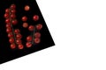 Cherry Tomat on Black Sheet Isolated on white Royalty Free Stock Photo