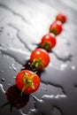 Cherry tomato on a black background with water Royalty Free Stock Photo