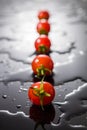 Cherry tomato on a black background with water Royalty Free Stock Photo