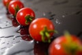 Cherry tomato on a black background with water Royalty Free Stock Photo