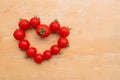 Cherry Tomato fresh in heart shape on wooden chopping board, flat lay Royalty Free Stock Photo