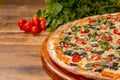 Cherry tomato pizza, black olive and basil on wooden background