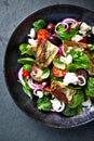 Cherry tomato and spinach salad with artichoke hearts, kalamata olives and feta cheese. Mediterranean cuisine. Flat lay