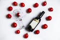 cherry tomatoes arranged in the form of heart with bottle of wine with glasses inside. Celebrate Valentine`s day. Royalty Free Stock Photo