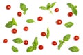 Cherry tomatoes and basil leaves on a white isolated background. Fresh vegetables. Pattern