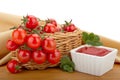 Cherry tomatoes in a basket and tomato paste