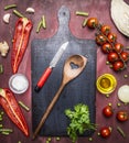 Cherry tomatoes, bell pepper, butter, cabbage, wooden salad spoon wooden rustic background top view