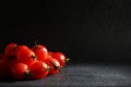 Cherry tomatoes on a black background in the spray Royalty Free Stock Photo