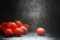 Cherry tomatoes on a black background in the spray Royalty Free Stock Photo