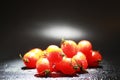 Cherry tomatoes on a black background in the spray Royalty Free Stock Photo