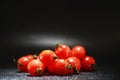 Cherry tomatoes on a black background in the spray Royalty Free Stock Photo