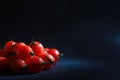 Cherry tomatoes on a black background in the spray Royalty Free Stock Photo