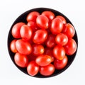 Cherry tomatoes in a black bowl isolated on white Royalty Free Stock Photo