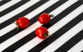 Cherry tomatoes on a black and white striped background Royalty Free Stock Photo