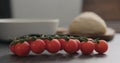 Cherry tomatoes branch on conrete countertop Royalty Free Stock Photo