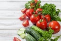 Cherry tomatoes on a branch, cucumber, parsley Royalty Free Stock Photo