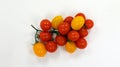 Cherry tomatoes on a branch of different colors yellow and red. Isolated on white. Ripe fresh juicy cherry tomatoes Royalty Free Stock Photo