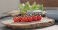 Cherry tomatoes branch on olive wood board Royalty Free Stock Photo