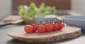 Cherry tomatoes branch on olive wood board Royalty Free Stock Photo