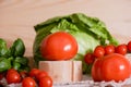 Cherry tomatoes, cabbage on a deervian background. preparation of salad. Summer concept of proper healthy eating. Royalty Free Stock Photo